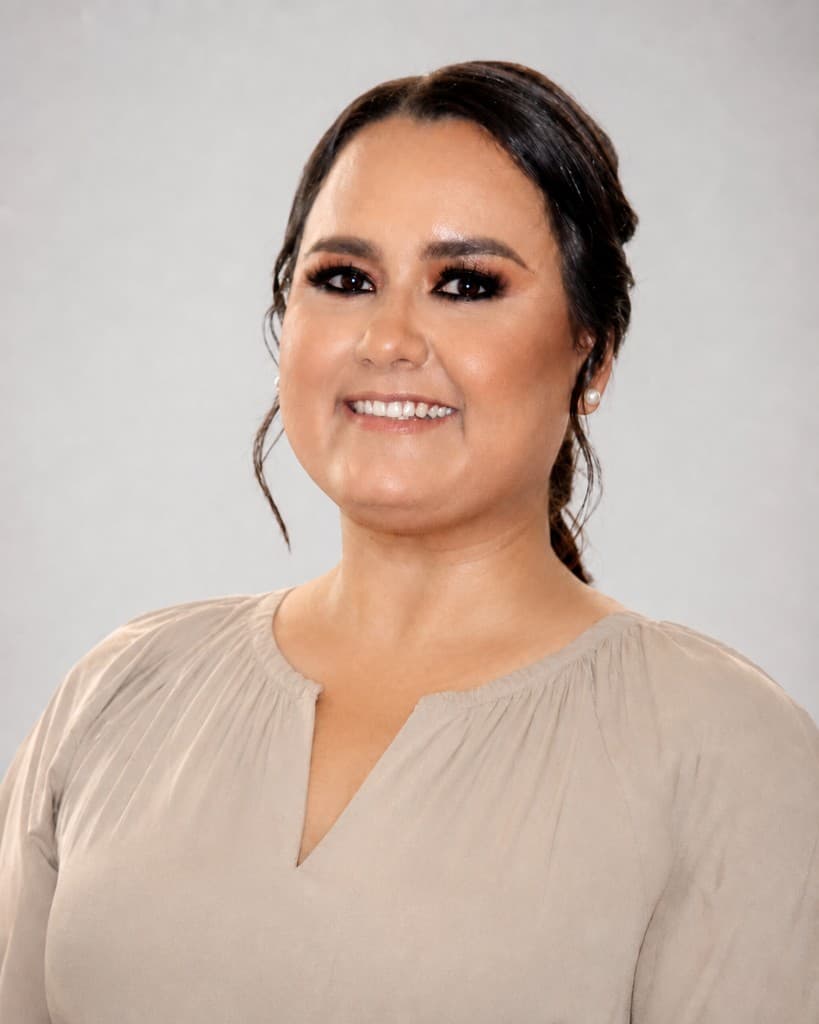 Professional portrait of Miriam Perez Vazquez, a licensed California insurance professional based in Chula Vista, smiling in business attire against a neutral studio backdrop.